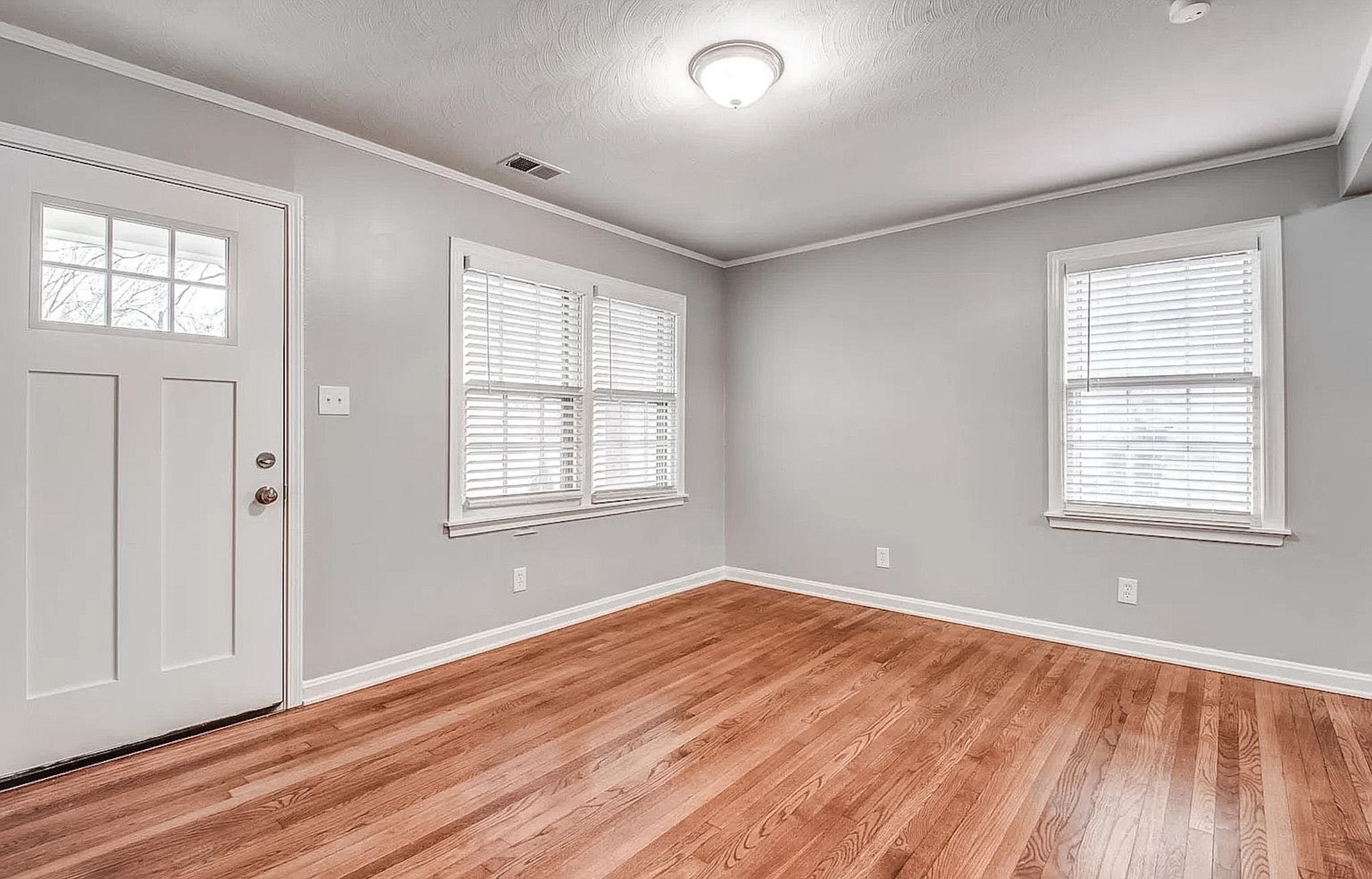 4402 Boyce Road Memphis, TN 38117 - Photo 3 of 13 a view of empty room with wooden floor and fan