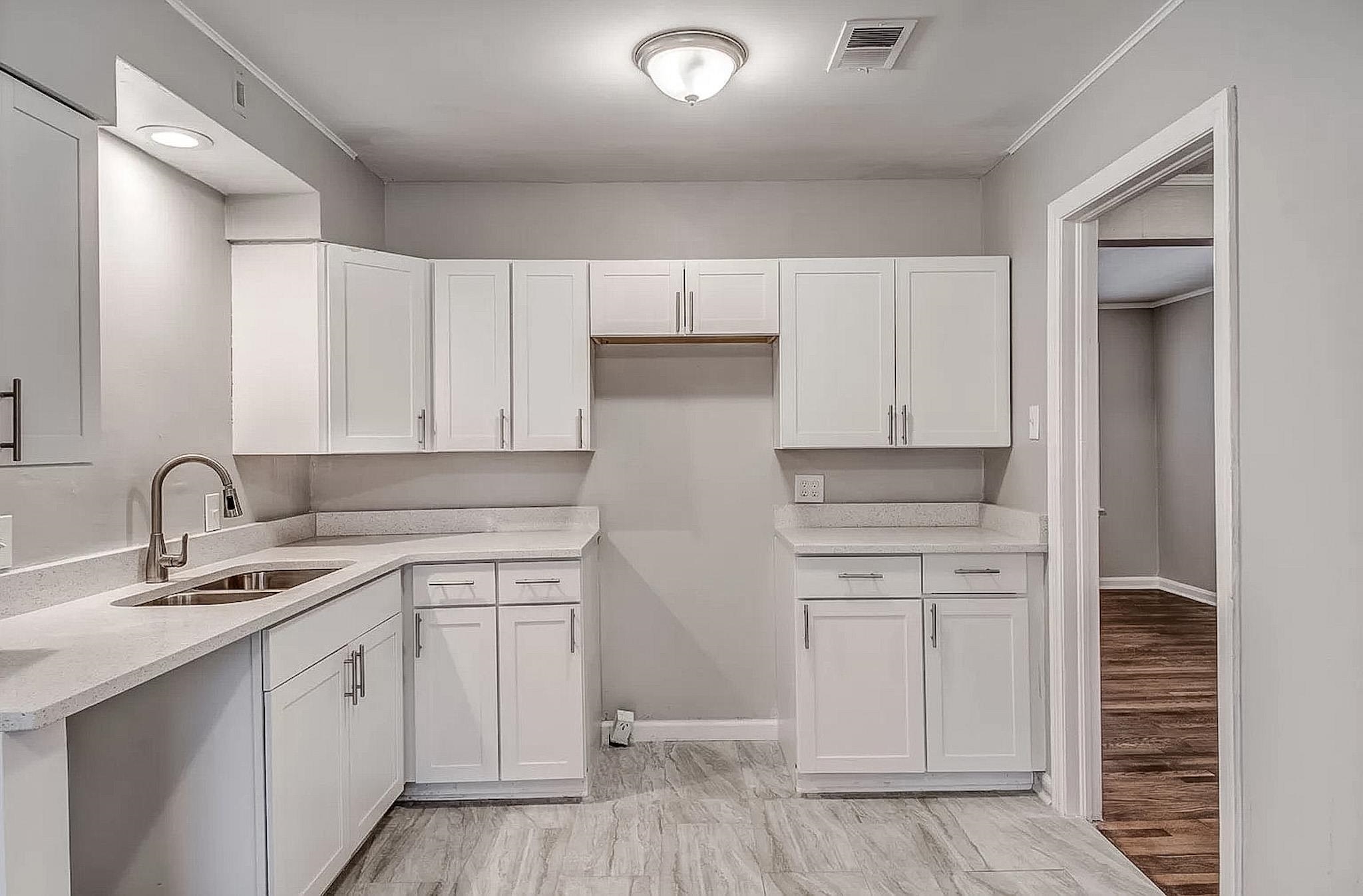 4402 Boyce Road Memphis, TN 38117 - Photo 5 of 13 a kitchen with white cabinets and white appliances