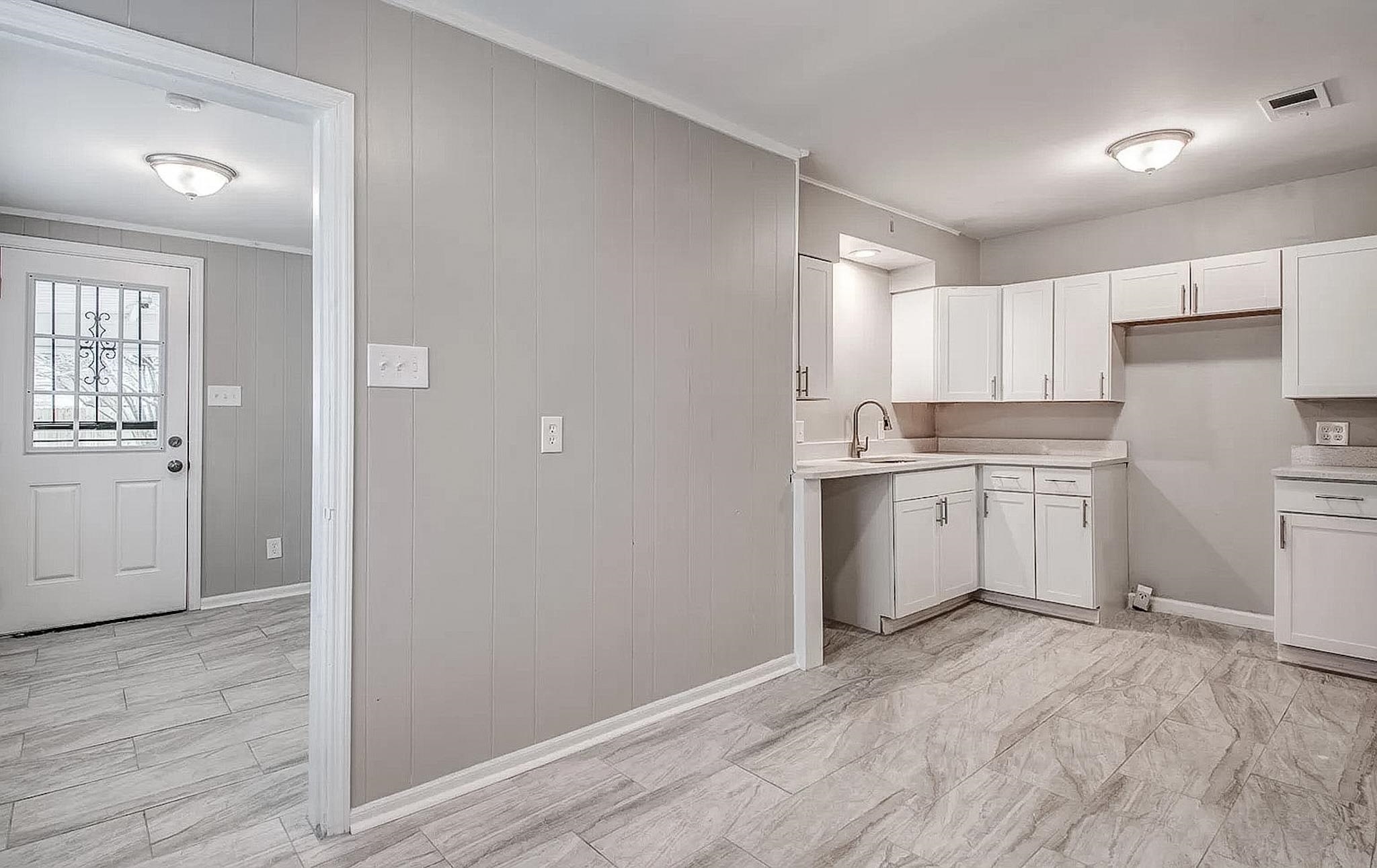 4402 Boyce Road Memphis, TN 38117 - Photo 6 of 13 a view of a kitchen with a sink and dishwasher with wooden floor