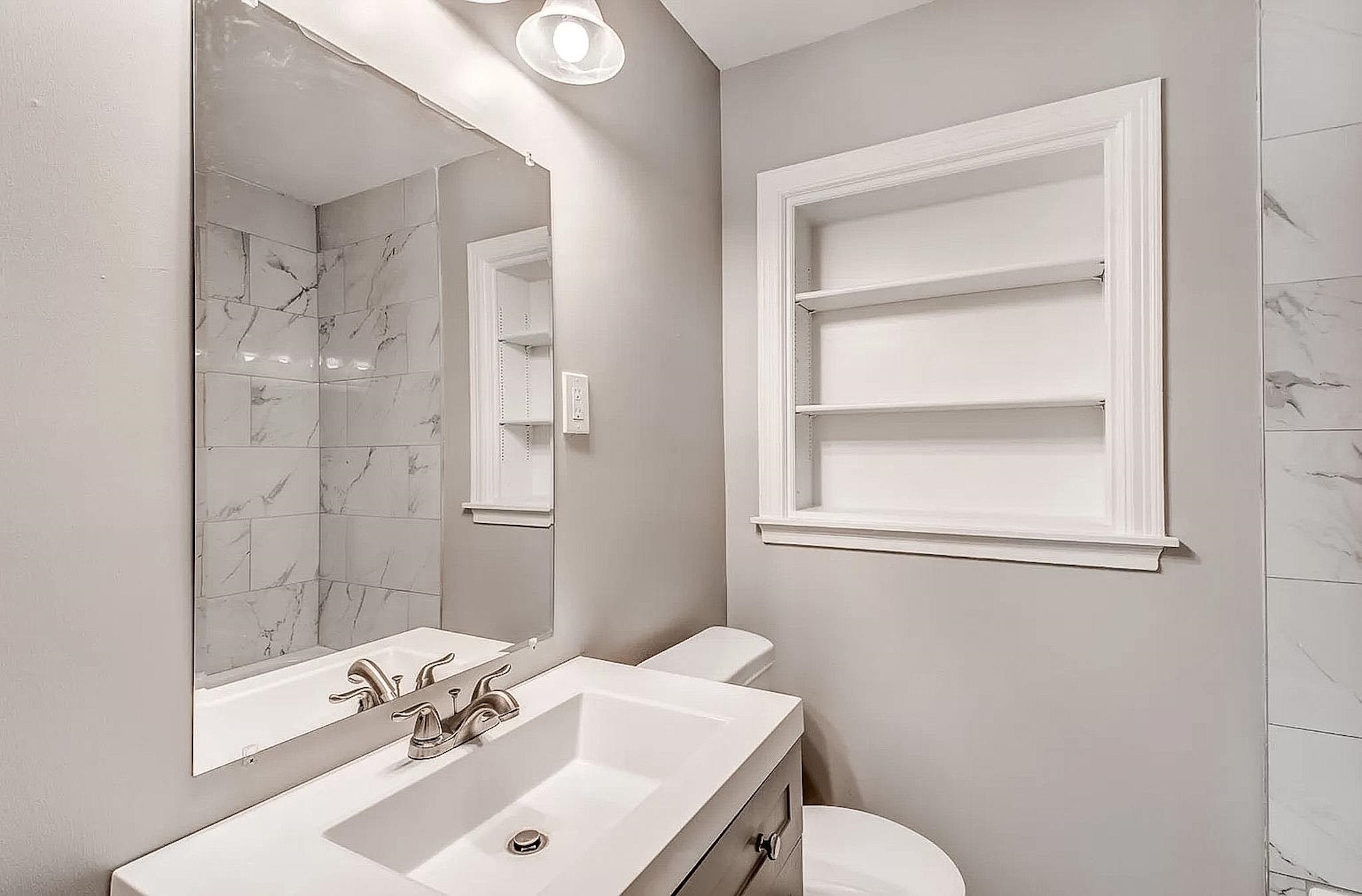 4402 Boyce Road Memphis, TN 38117 - Photo 10 of 13 a bathroom with a sink a toilet and shower