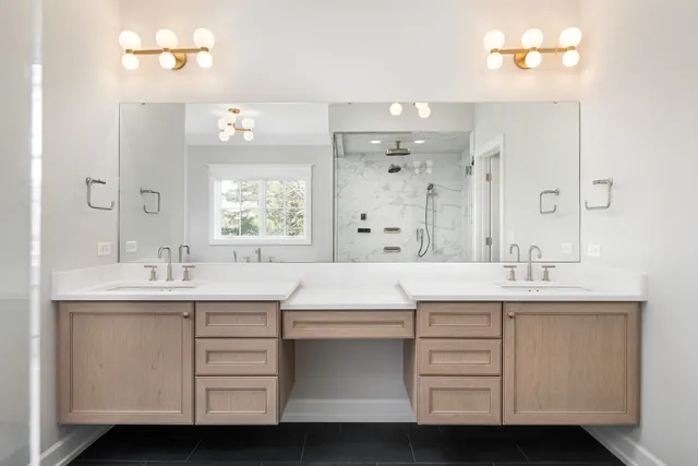 a large bathroom with a tub sink shower and mirror
