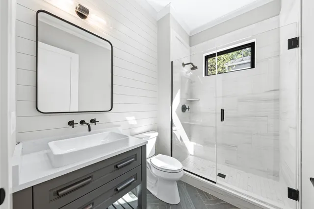 a view of hallway with window and wooden floor
