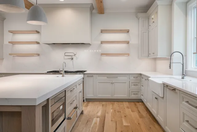 a kitchen with cabinets appliances and a window