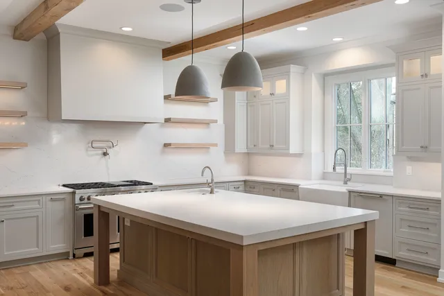 a kitchen with stainless steel appliances a sink a stove and a wooden floor