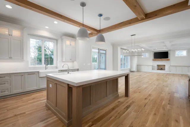 a kitchen with a stove and a wooden floor