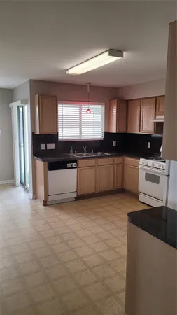 a kitchen with stainless steel appliances granite countertop a sink and stove