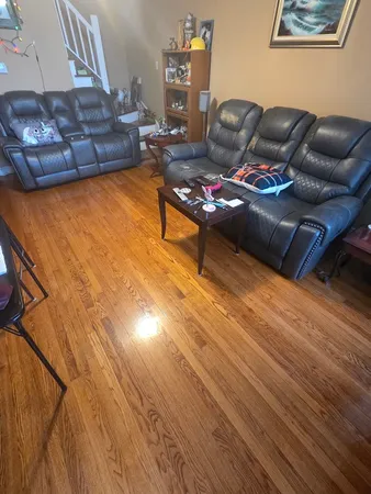 a living room with furniture and wooden floor