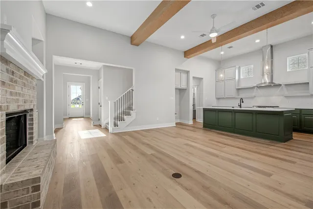 a view of an empty room with a fireplace and a window
