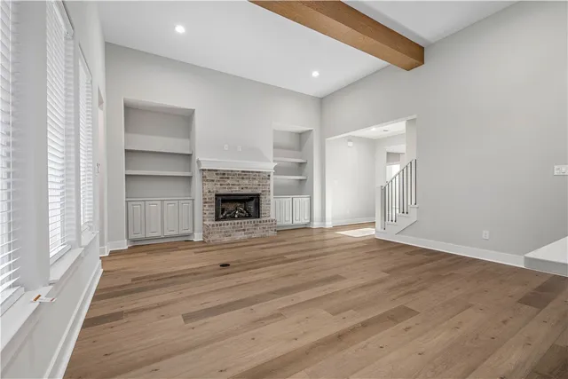 a kitchen with a sink cabinets and wooden floor