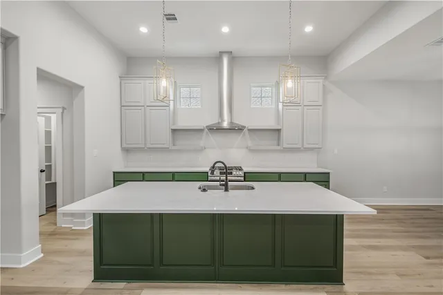 a kitchen with stainless steel appliances a sink a stove and cabinets