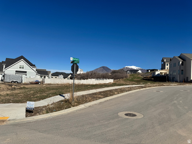 3583 South Mapleton Drive, Unit 13 Mapleton, UT 84664 - Photo 6 of 14 View of asphalt road featuring a residential view, sidewalks, and curbs