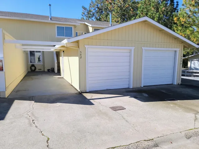 a view of a small house with garage