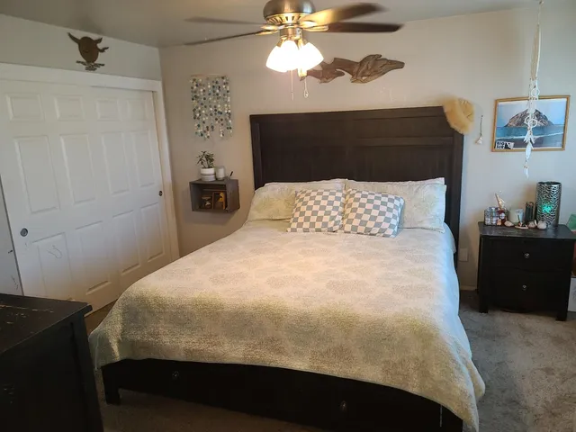 a bedroom with a bed and a chandelier