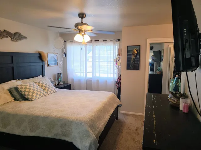 a bedroom with a large bed and a chandelier