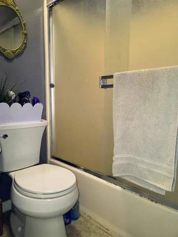 a bathroom with a toilet a sink and bathtub