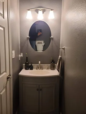 a bathroom with a sink and mirror