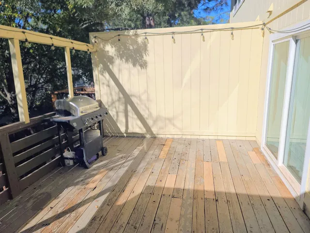 a view of a balcony with wooden floor