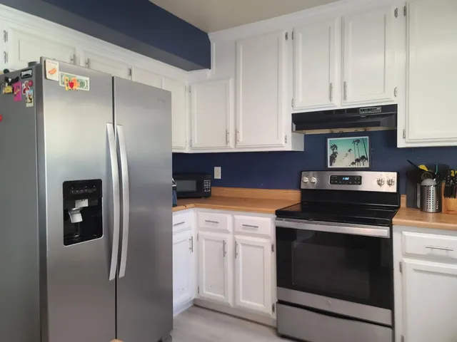 a kitchen with cabinets and stainless steel appliances