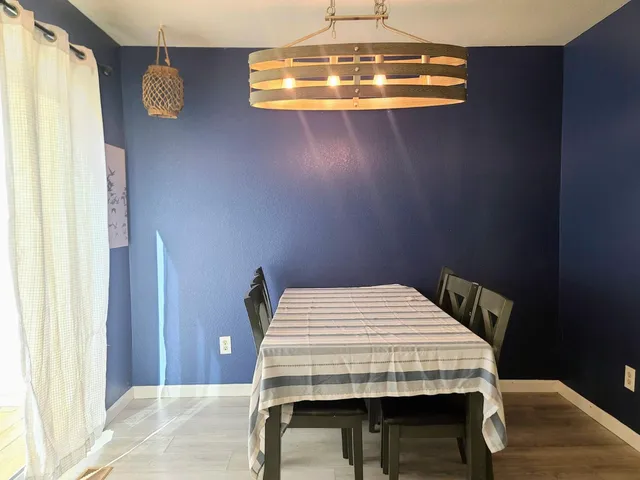 a bedroom with a bed and chandelier