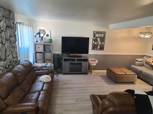 a living room with furniture and a flat screen tv
