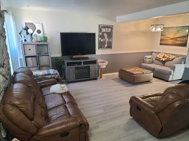 a living room with furniture and a flat screen tv