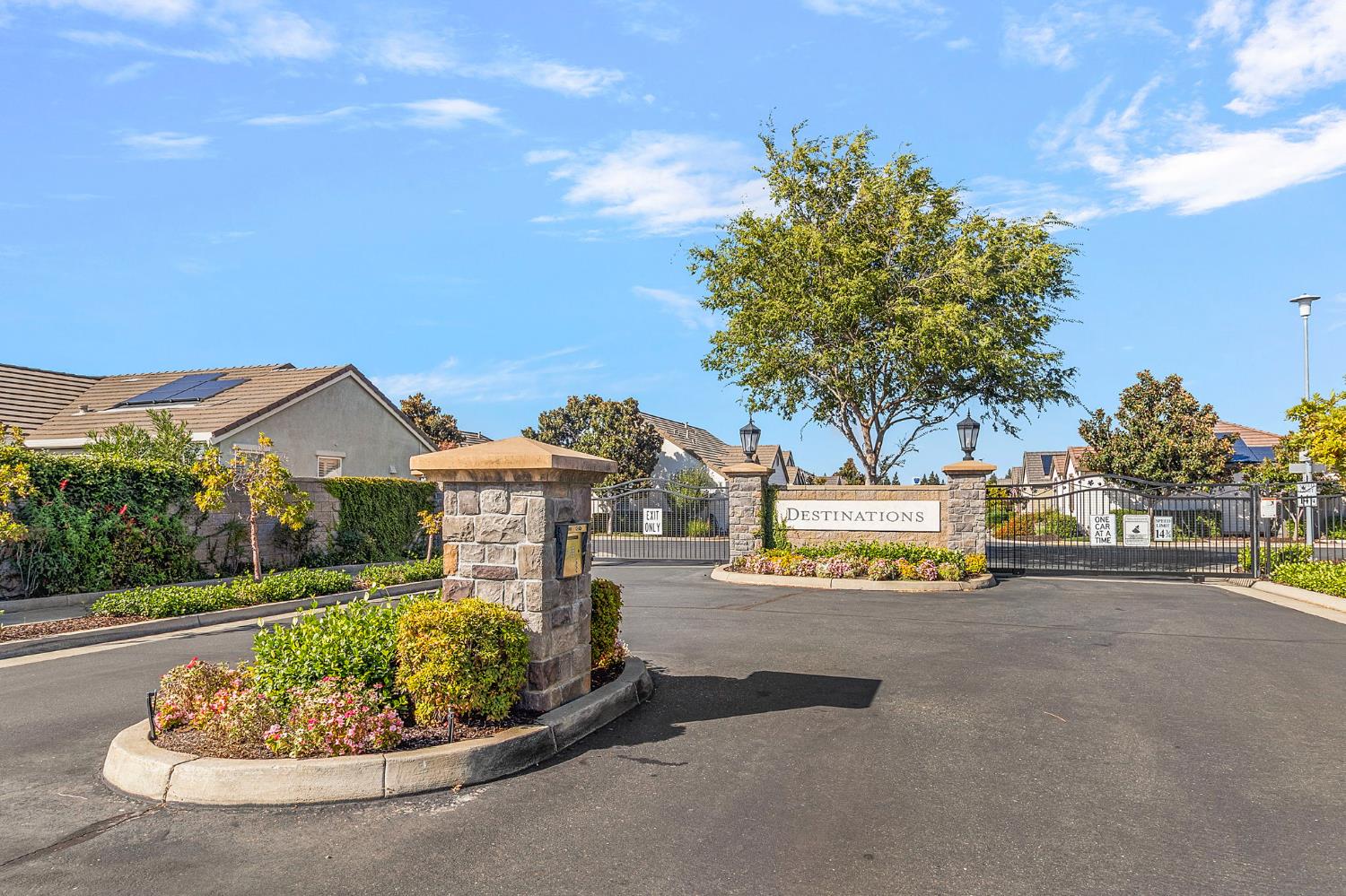 7525 Eldred Way Sacramento, CA 95829 - Photo 27 of 38 view of asphalt street with curbs, a gated entry, and a gate