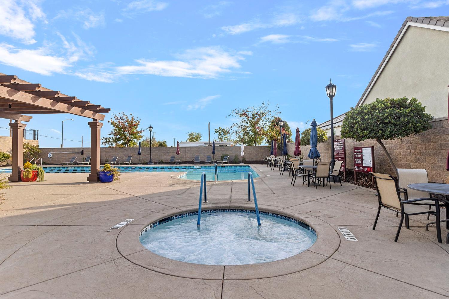 7525 Eldred Way Sacramento, CA 95829 - Photo 30 of 38 community pool with a community hot tub, a patio, a pergola, and a fenced backyard