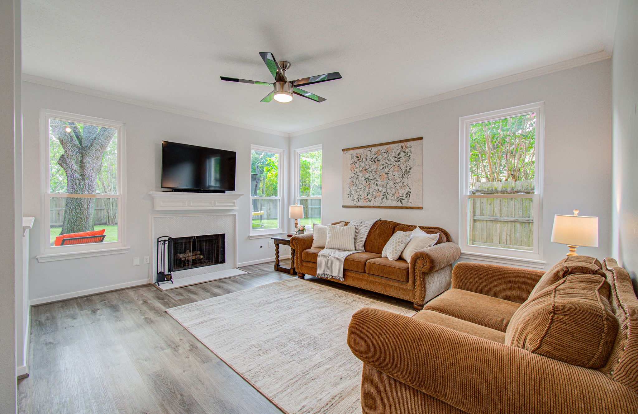 22927 Northoak Forest Lane Spring, TX 77389 - Photo 13 of 37 a living room with furniture a flat screen tv and a fireplace