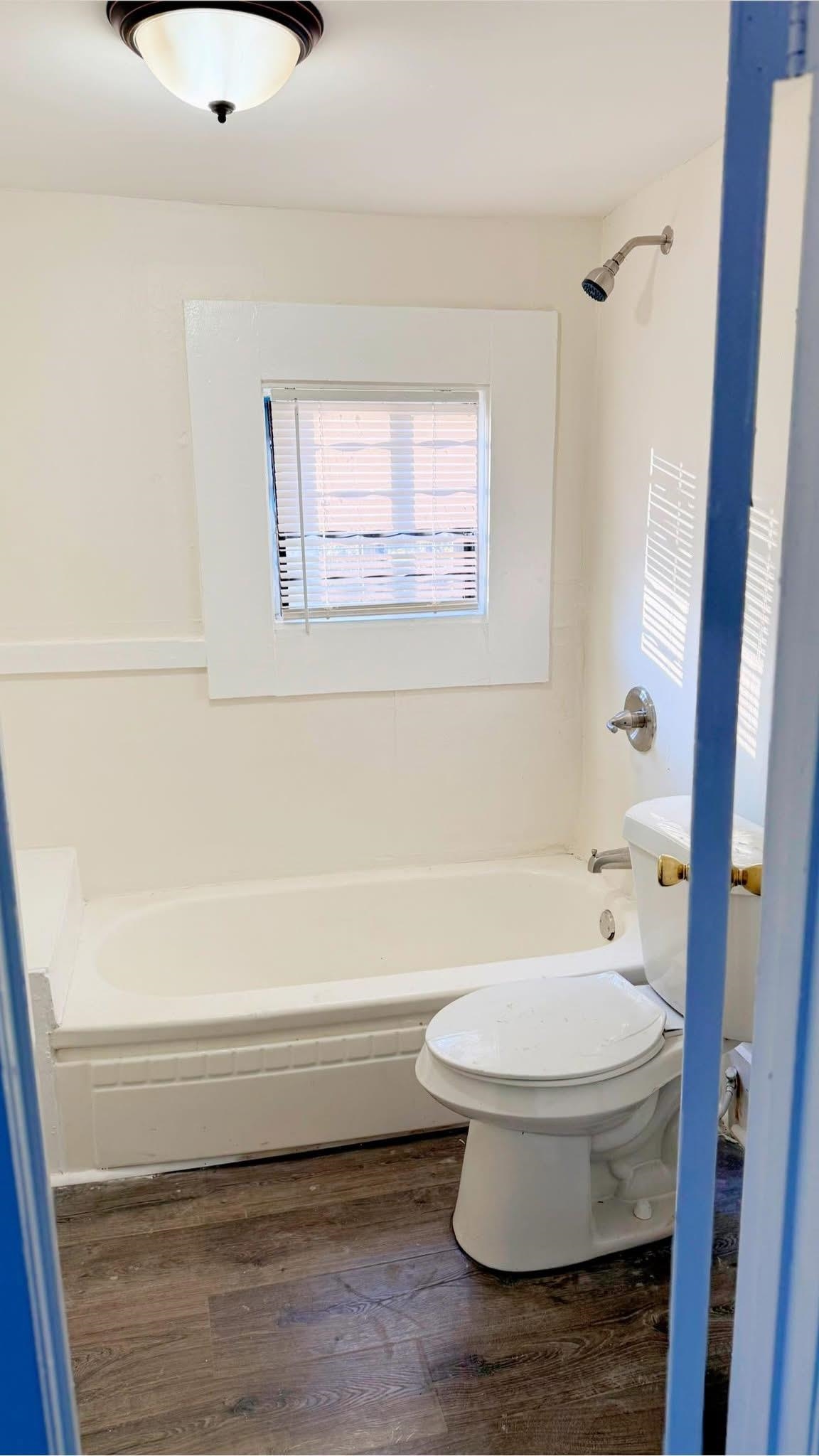 1393 Michigan Street Memphis, TN 38106 - Photo 4 of 9 Bathroom with bathtub / shower combination, wood-type flooring, and toilet
