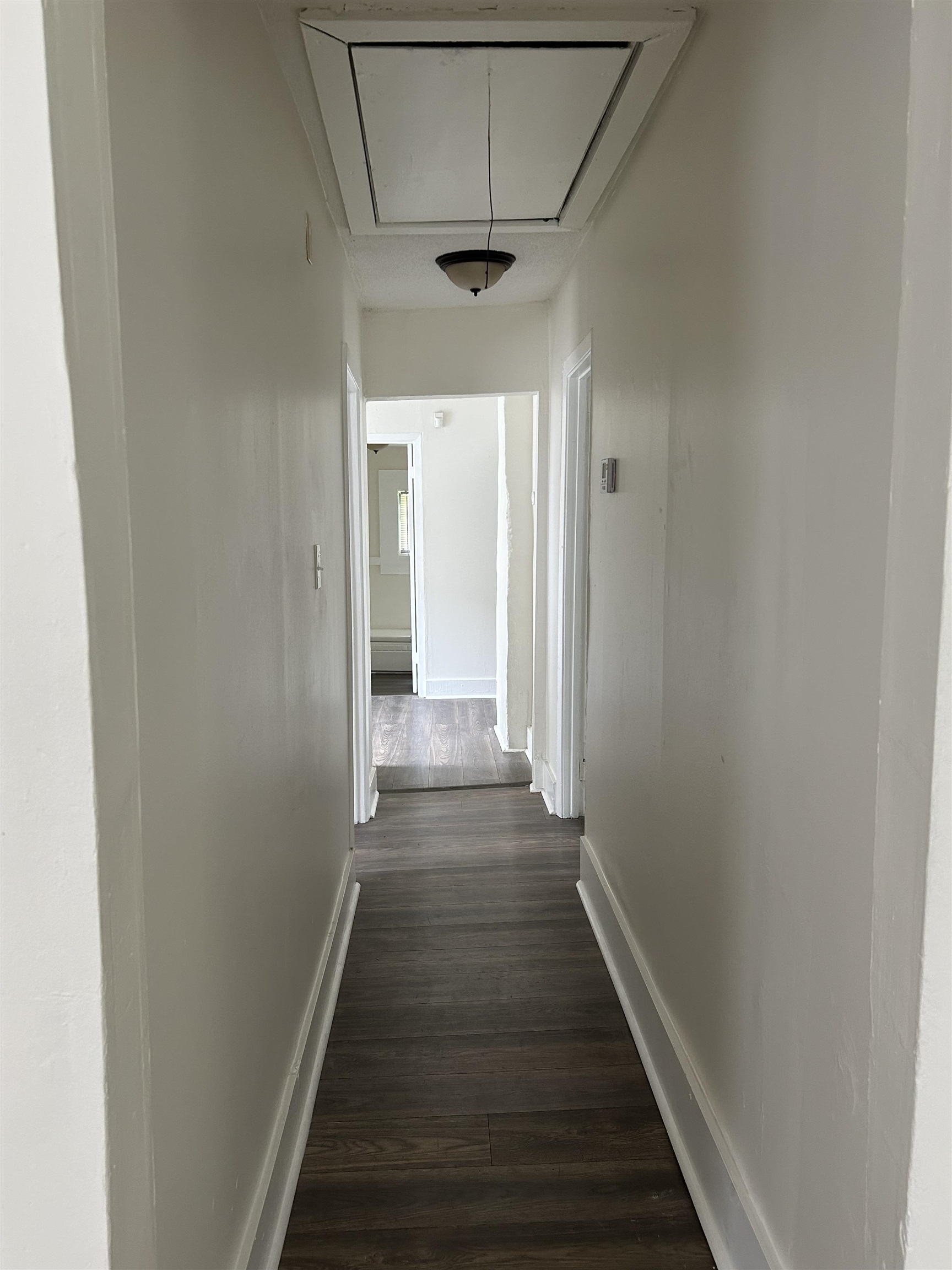 1393 Michigan Street Memphis, TN 38106 - Photo 8 of 9 Corridor featuring attic access and dark wood-style flooring