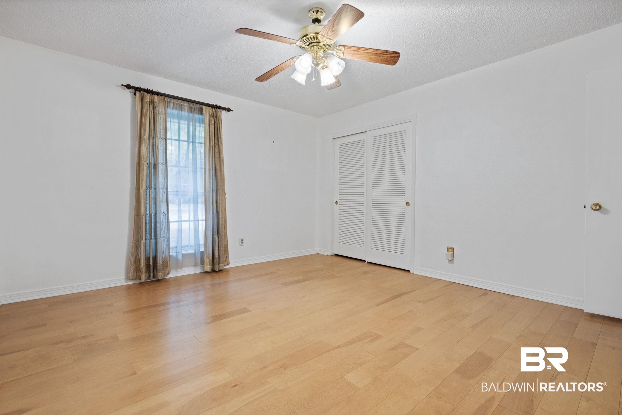 6261 Old Pascagoula Road Theodore, AL 36582 - Photo 23 of 29 Empty room with ceiling fan, a textured ceiling, and light wood-type flooring