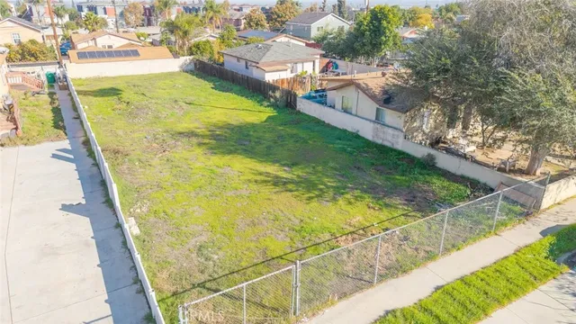 an aerial view of residential houses with yard