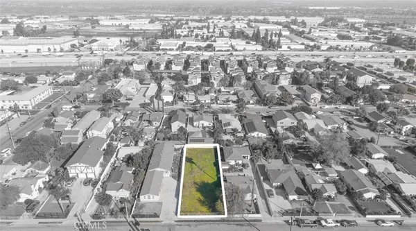 an aerial view of residential houses with city view