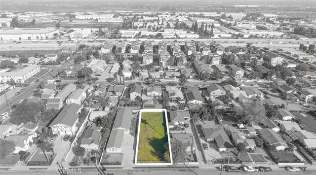 an aerial view of residential houses with city view