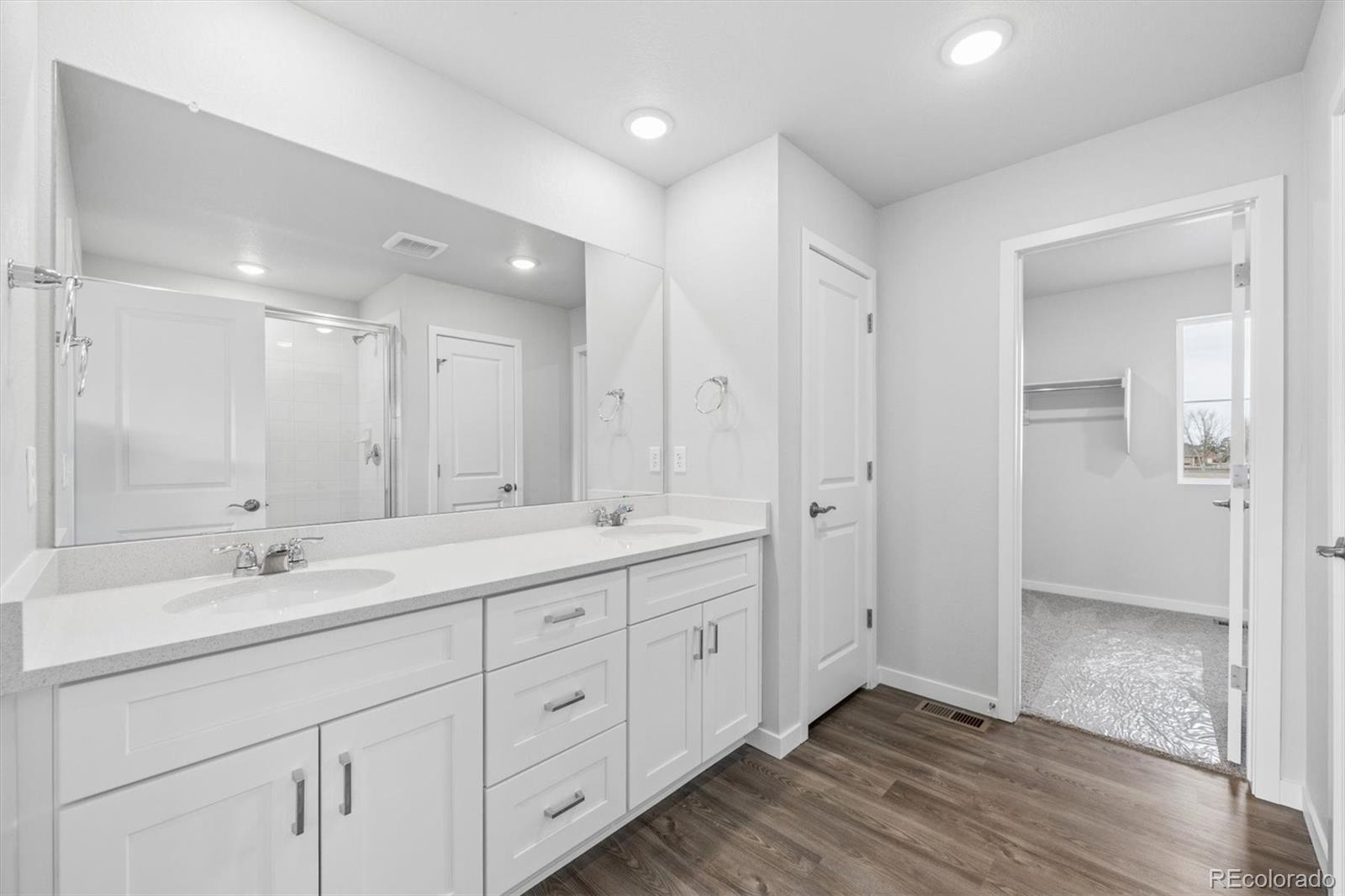 1414 Farmstead Street Brighton, CO 80601 - Photo 15 of 26 a spacious bathroom with a double vanity sink mirror and double