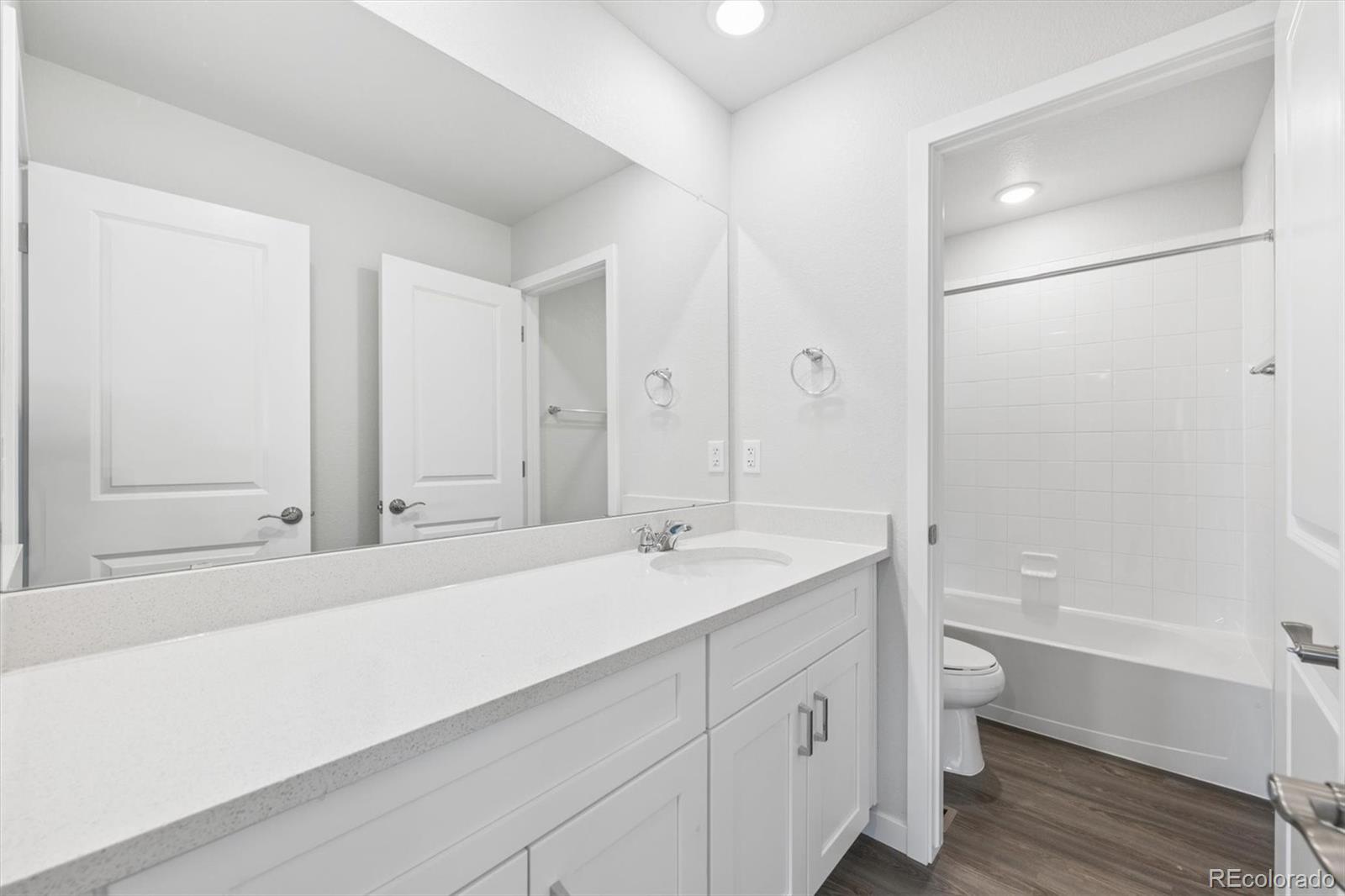 1414 Farmstead Street Brighton, CO 80601 - Photo 18 of 26 a bathroom with a tub sink and mirror