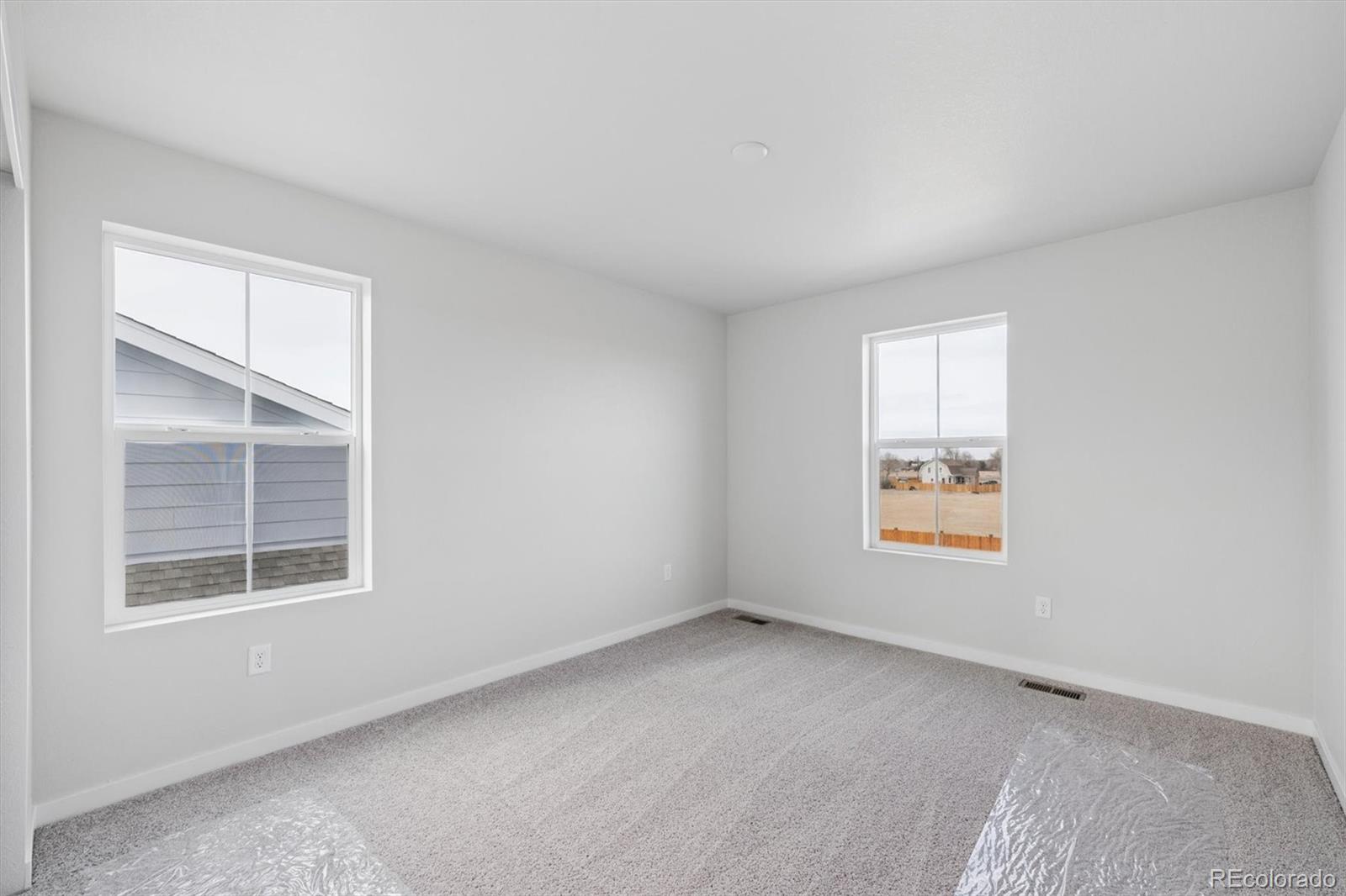1414 Farmstead Street Brighton, CO 80601 - Photo 20 of 26 an empty room with windows