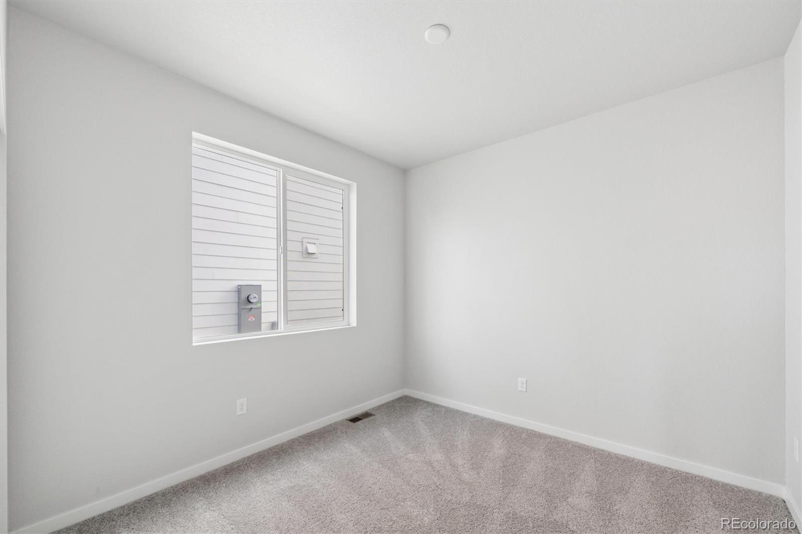1414 Farmstead Street Brighton, CO 80601 - Photo 5 of 26 an empty room with a window