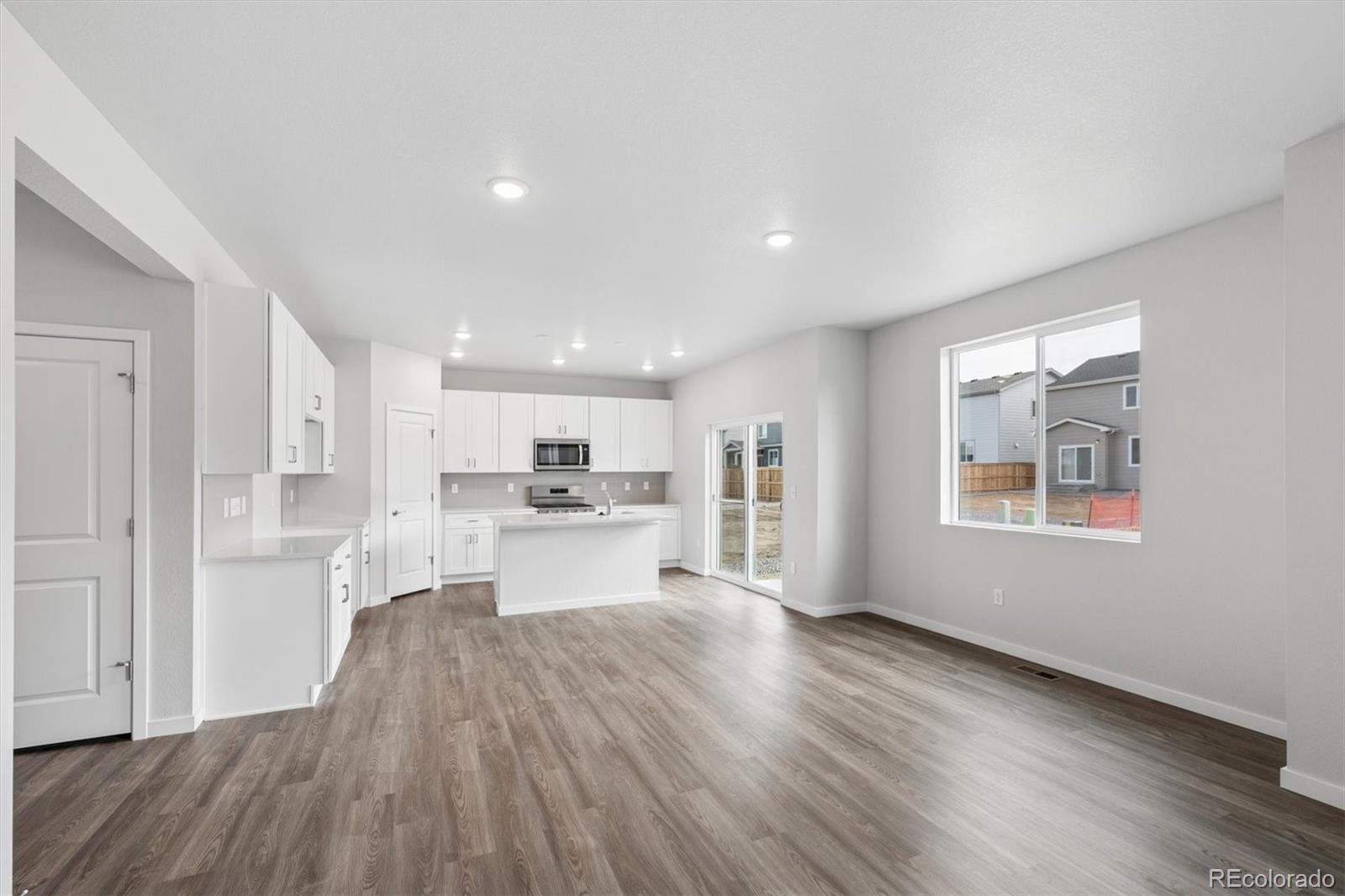 1414 Farmstead Street Brighton, CO 80601 - Photo 6 of 26 a view of kitchen with wooden floor and electronic appliances