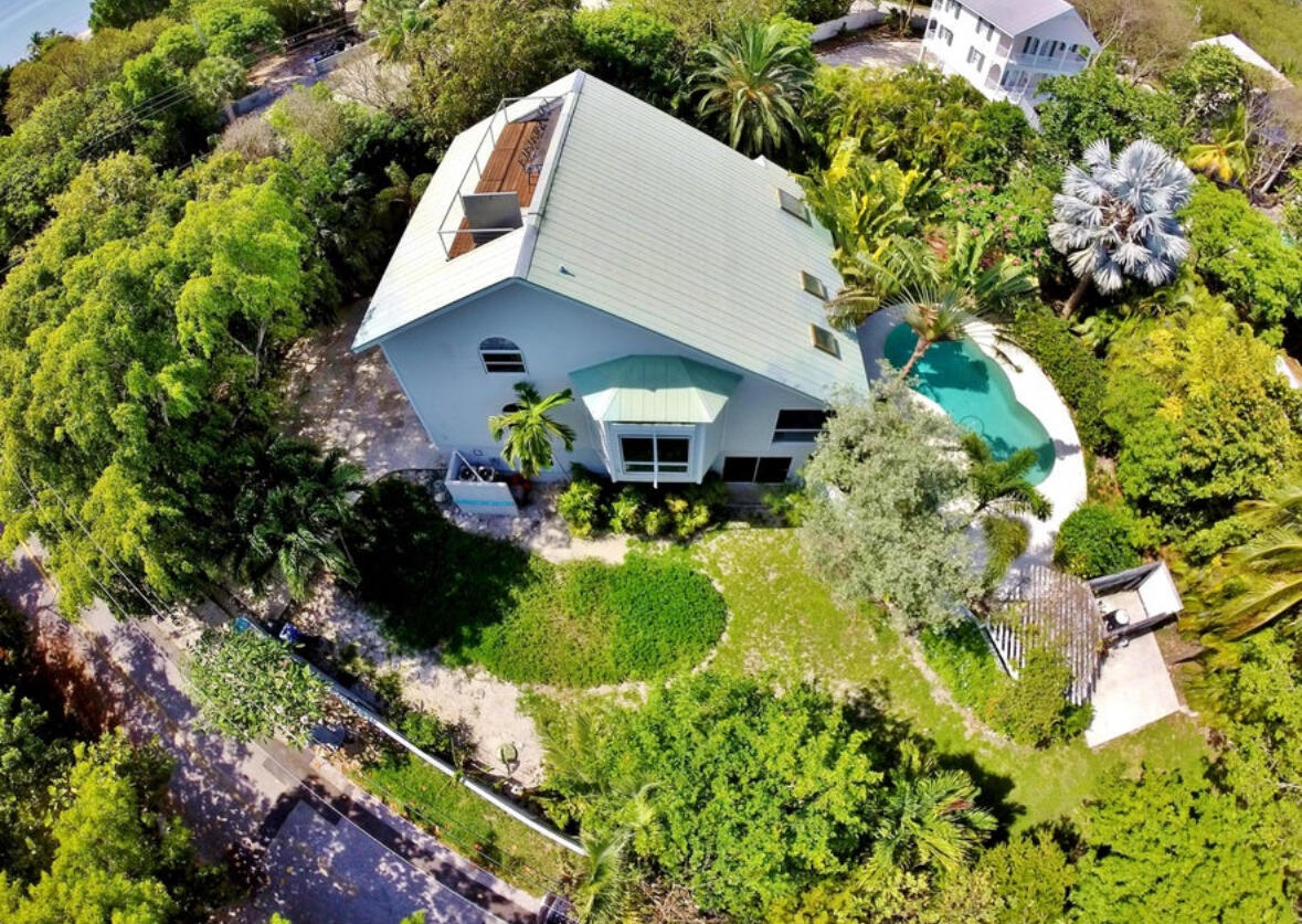a aerial view of a house with a yard and garden