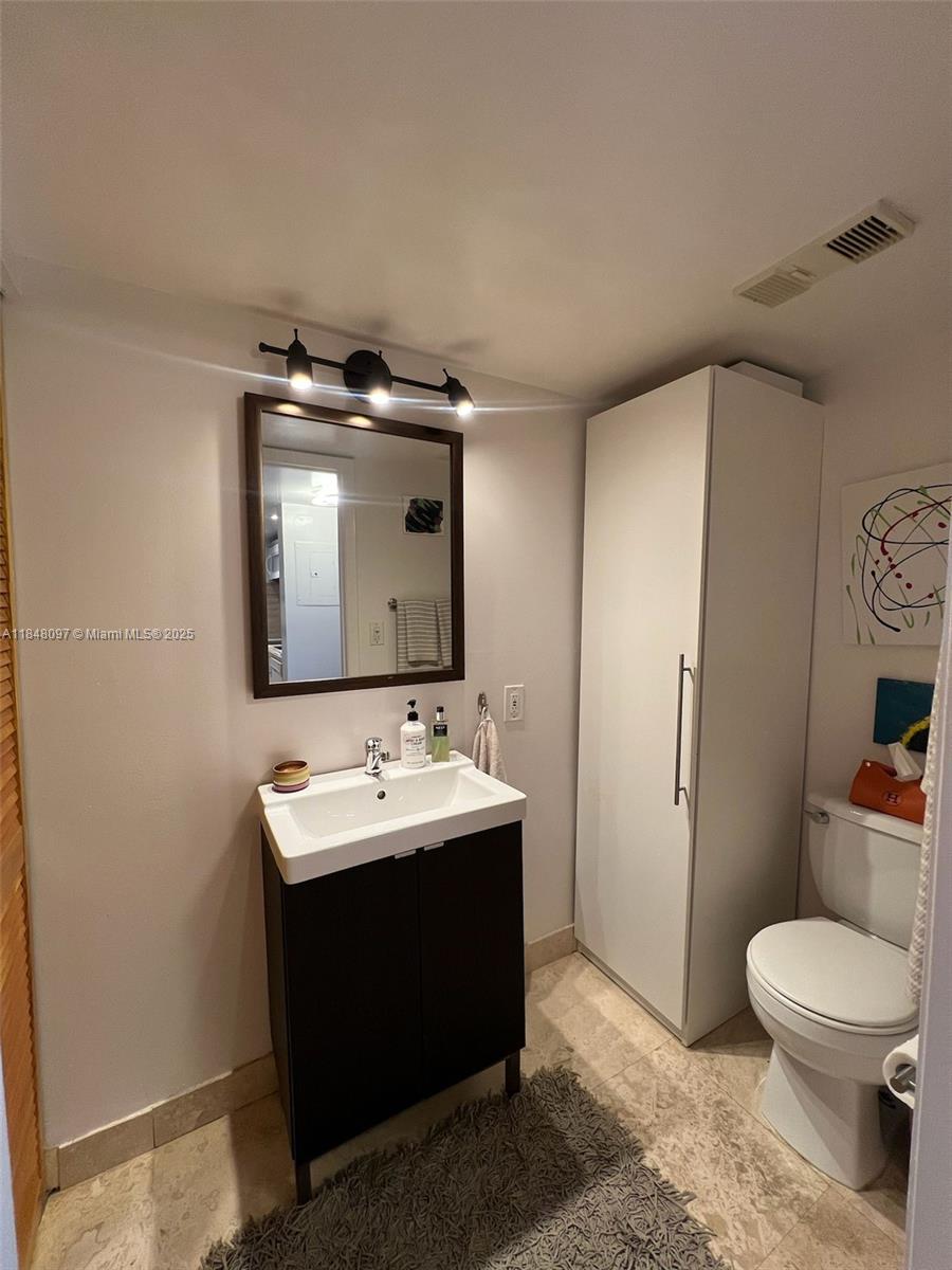 540 Brickell Key Drive, Unit 1524 Miami, FL 33131 - Photo 14 of 44 a bathroom with a toilet sink and mirror