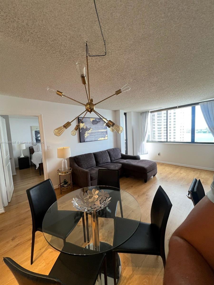 540 Brickell Key Drive, Unit 1524 Miami, FL 33131 - Photo 2 of 44 a living room with furniture and a wooden floor