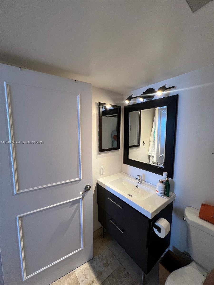 540 Brickell Key Drive, Unit 1524 Miami, FL 33131 - Photo 23 of 44 a bathroom with a sink and a mirror