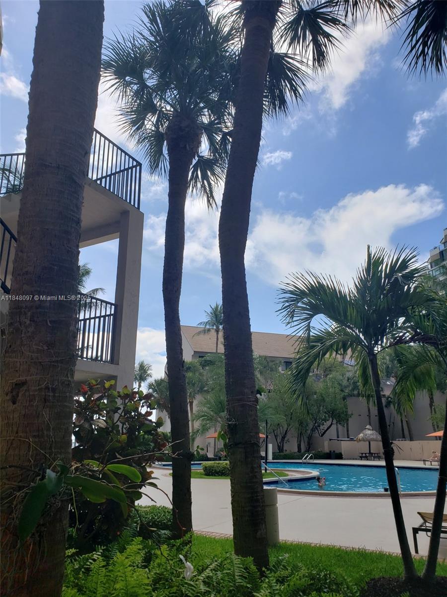 540 Brickell Key Drive, Unit 1524 Miami, FL 33131 - Photo 30 of 44 a view of a swimming pool with a garden