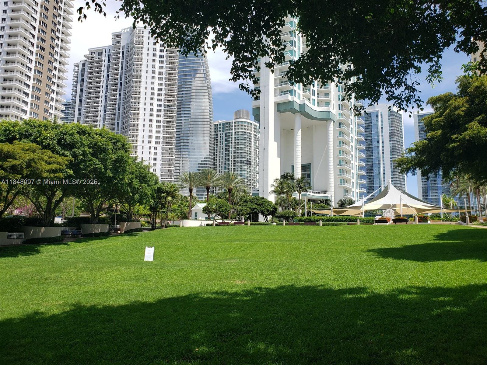 540 Brickell Key Drive, Unit 1524 Miami, FL 33131 - Photo 39 of 44 a view of a house with a backyard and a tree