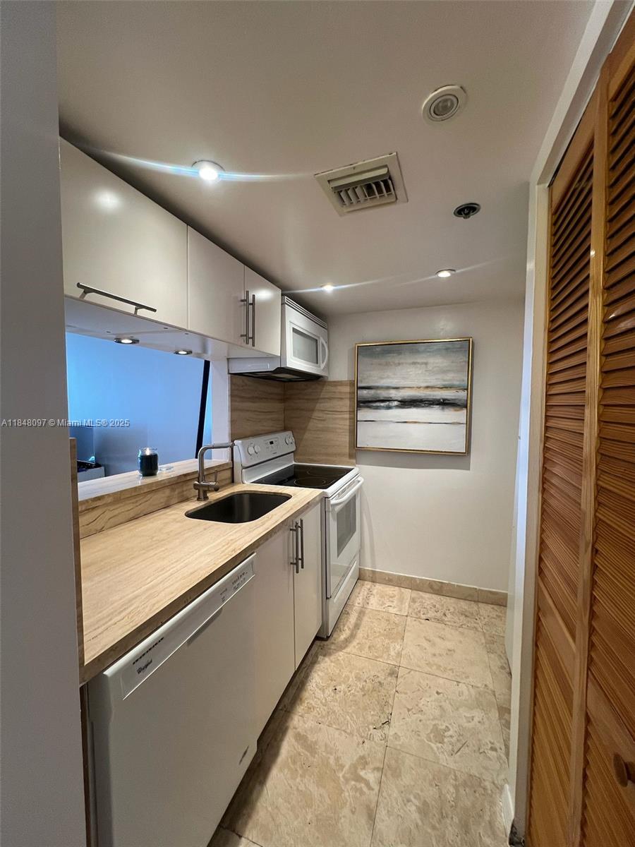 540 Brickell Key Drive, Unit 1524 Miami, FL 33131 - Photo 6 of 44 a kitchen with a stove and a refrigerator