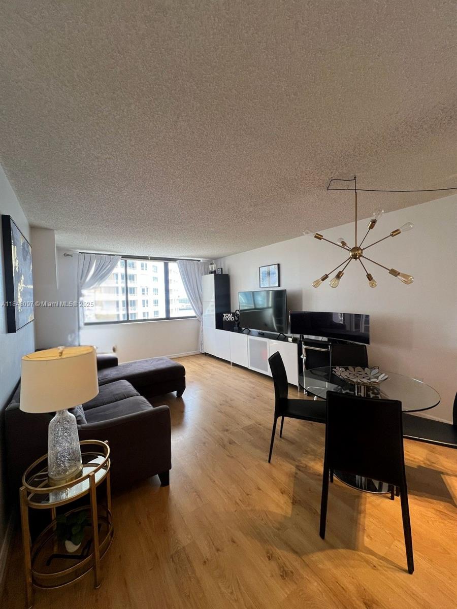 540 Brickell Key Drive, Unit 1524 Miami, FL 33131 - Photo 7 of 44 a living room with furniture and a window