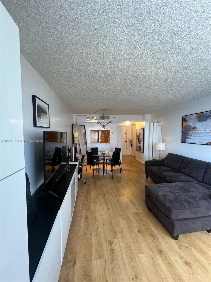 540 Brickell Key Drive, Unit 1524 Miami, FL 33131 - Photo 8 of 44 a living room with furniture and a wooden floor