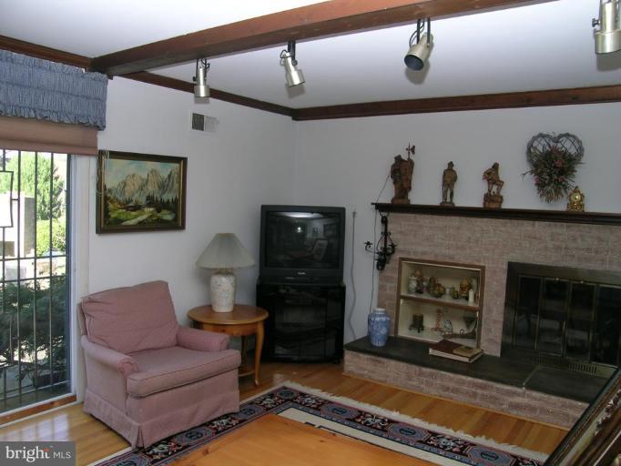 13900 Alderton Road Silver Spring, MD 20906 - Photo 9 of 11 Wood burning fireplace and hardwood floors