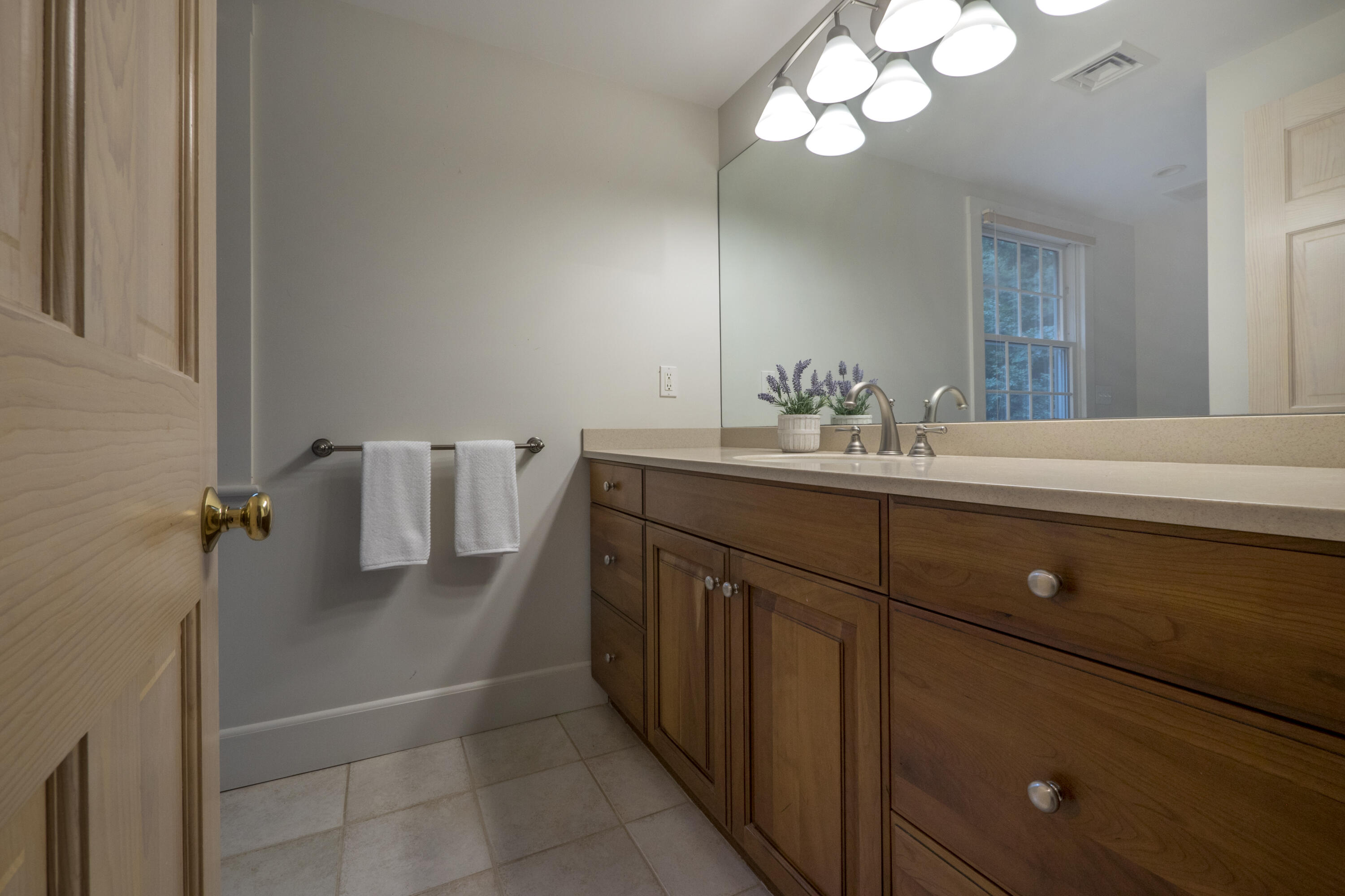303 Maple Street West Barnstable, MA 02668 - Photo 10 of 19 a bathroom with a sink a mirror and a light fixture